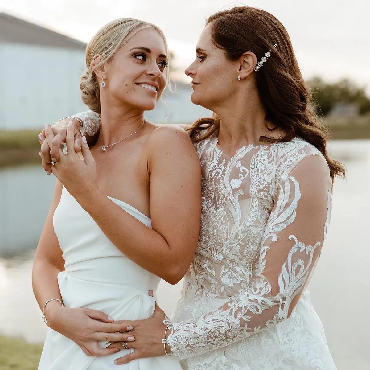 Front portrait of Paige and her partner showing her bespoke lace wedding dress
